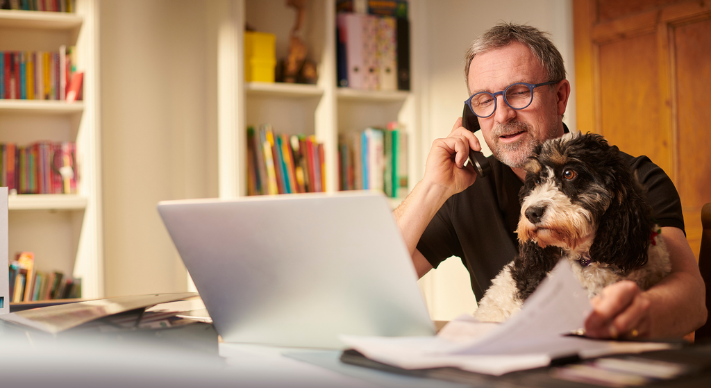 man and dog looking at computer