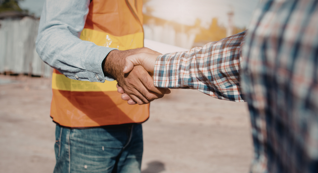 Two contractors shaking hands