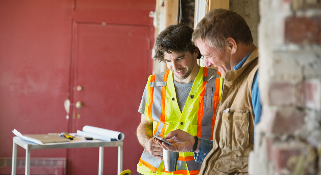 Contractors looking at a phone